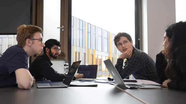 Quantum computing for all Young people working on laptops