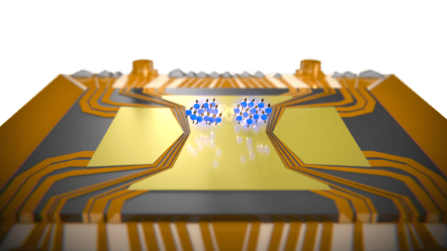 EPR paradox_web Artist’s depiction of two spatially separated entangled rubidium atom clouds on top of a micro-fabricated gold atom chip. The atom clouds are shown as blue dots and sit in the middle of gold wiring on the chip