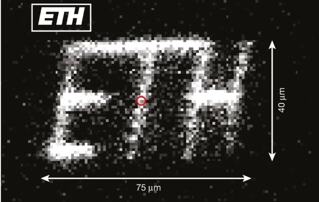 ETH logo in ions Black and white image showing the letters ETH formed from many individual dots of light
